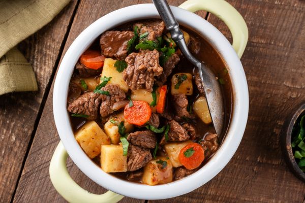 Beef stew with carrots and potatoes in a bowl.
